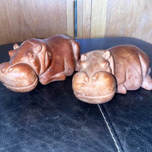 Vintage hippo sculptures // carved wood hippopotamus figurines two tabletop hippos laid down