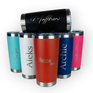 May include: An assortment of insulated tumblers in black, teal, white, red, blue, and pink. Each tumbler has a silver rim and lid, with personalised text in a cursive font. The text includes names and a business logo.