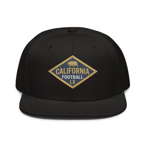 May include: Black baseball cap with a flat peak. The cap has a diamond-shaped emblem with the words "CALIFORNIA FOOTBALL LX" in gold lettering, and a gold bear graphic. A classic, sporty accessory.