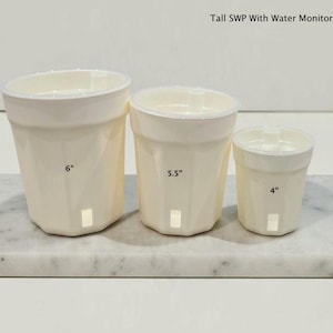 May include: Three off-white, faceted plant pots labeled Tall SWP With Water Monitor. The pots are sized 6 inches, 5.5 inches, and 4 inches, each featuring a small rectangular drainage or water level window near the base.