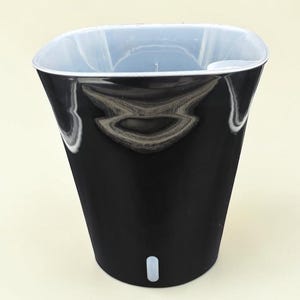 May include: A glossy black planter with a white interior liner and a small white indicator window near the base. The planter features a tapered square shape and is labeled with the text 10.5" SWP printed in black at the bottom of the image.