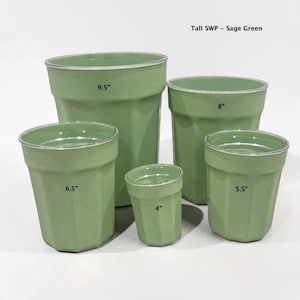 May include: Five sage green planters labeled Tall SWP - Sage Green with heights of 9.5 inches, 8 inches, 6.5 inches, 5.5 inches, and 4 inches. Each cylindrical container features a smooth finish, a slightly flared rim, and a faceted base.