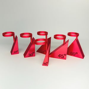 May include: A collection of six bright red, geometric display stands. Each stand features a triangular base with a circular top and is labeled with a degree measurement: 15°, 22°, 30°, 37°, 45°, and 60°.