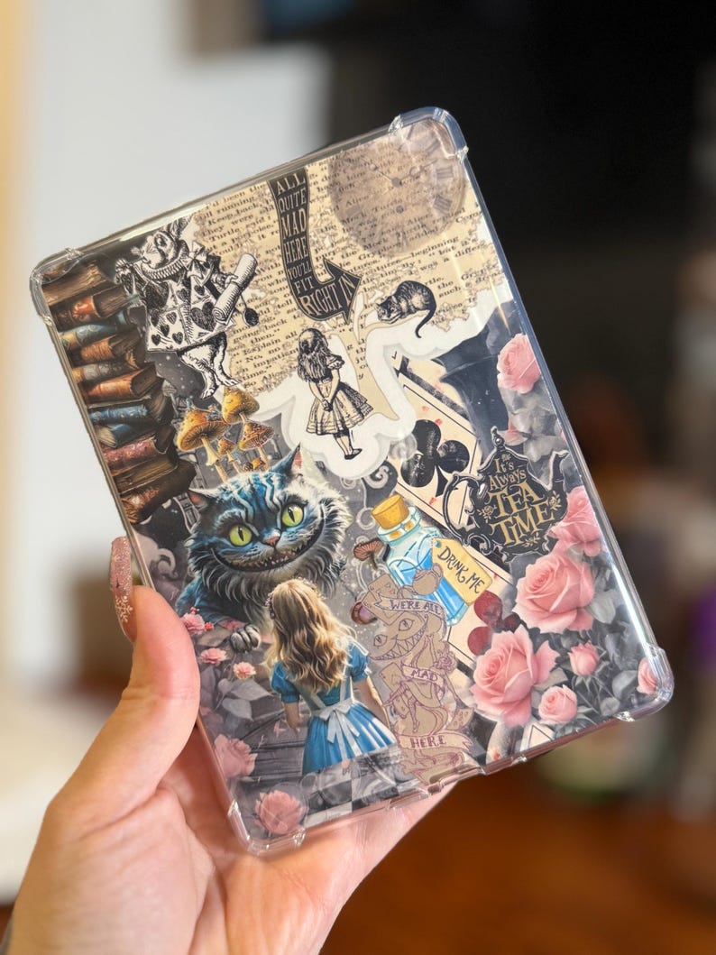 May include: Clear phone case featuring Alice in Wonderland imagery. The design includes illustrations of the Cheshire Cat, Alice, roses, and text elements. The case has a transparent border.