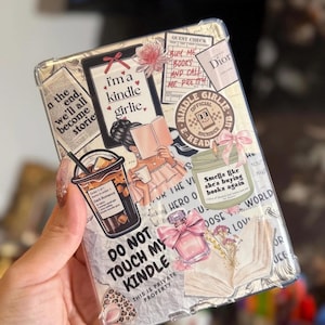May include: Clear Kindle case with a collage design featuring illustrations of books, coffee, perfume, and the text "I'm a Kindle Girlie." The case also has the text "Do Not Touch My Kindle."