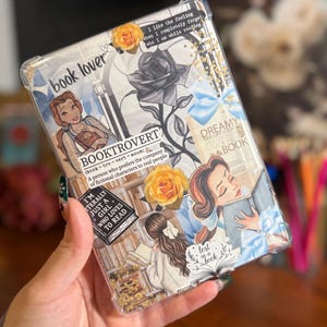 May include: Clear tablet case with a collage design featuring illustrations of Belle from Beauty and the Beast, roses, and book-related quotes. The case has the words "book lover" and "Booktrovert" printed on it.