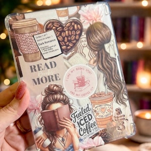May include: Clear phone case with a design featuring coffee cups, coffee beans, and illustrations of women reading. The case includes the text "READ MORE" and "Fueled by Iced Coffee & Unstoppable Chaos."