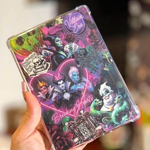 May include: A clear phone case featuring a collage of Disney villains. The design includes images of Maleficent, Ursula, and the Evil Queen, with text that reads "Villain Era", "Breaking Hearts", and "Good Girls Read Bad Books".