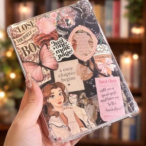 May include: A white ceramic mug with a black handle and the text "But First, Coffee" in a black, handwritten-style font. The mug is on a white surface.