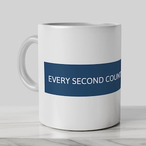 May include: White ceramic mug with a blue stripe and the text "EVERY SECOND COUNTS" in white.