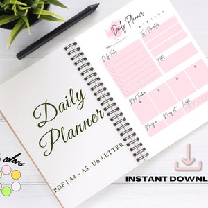 Peut inclure: Un planificateur quotidien rose et blanc avec une reliure spirale. Le planificateur comprend des sections pour les tâches quotidiennes, le suivi des repas, l'argent entrant et sortant, l'apport en eau et une section pour les priorités. Le planificateur est disponible en six couleurs et est imprimable en format A4, A5 et US Letter.