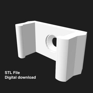 May include: A white, 3D-rendered bracket with a circular hole in the center. The bracket has a rectangular shape with rounded edges and is set against a black background. Text on the image reads "STL File Digital download."