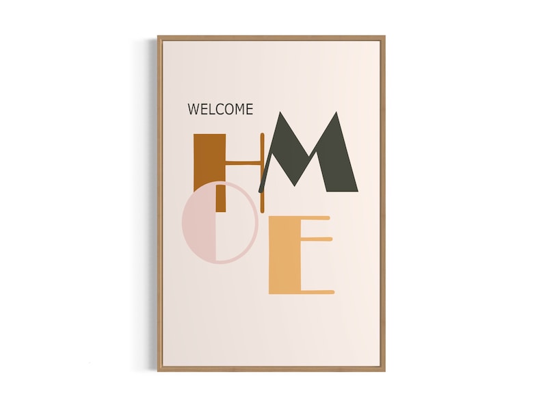 May include: A framed print with the word "WELCOME" at the top and the word "HOME" in stylized, geometric letters in orange, brown, pink, and black on a light beige background.