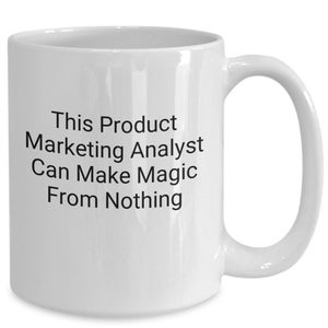 May include: White ceramic coffee mug with black text that reads "This Product Marketing Analyst Can Make Magic From Nothing."