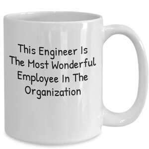 May include: White ceramic coffee mug with a black inscription that reads "This Engineer Is The Most Wonderful Employee In The Organisation".