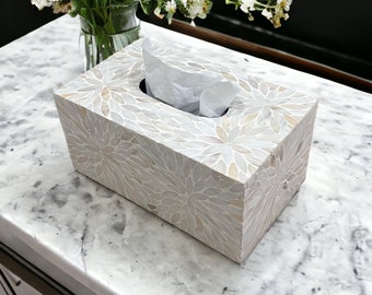 May include: A white tissue box cover with a floral pattern made of mother of pearl. The cover is sitting on a white marble surface.