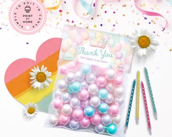 May include: A clear bag filled with pastel-colored pearls, with a "Thank You" message for a party. The image includes daisies, colorful ribbons, confetti, and decorative pencils. A heart-shaped decoration with a rainbow stripe is also present.