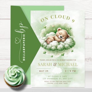 May include: A baby shower invitation in green and white. The design features a sleeping teddy bear on a cloud, with stars. The text reads "On Cloud 9" and includes details for Sarah & Michael's baby shower. The invitation is accompanied by a green envelope.