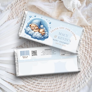 May include: A blue and white chocolate bar wrapper with a cartoon bear wearing a blue hat sleeping on a cloud. The wrapper says "Thank you for coming Macy & Kevin's Baby Shower May 25, 2025".