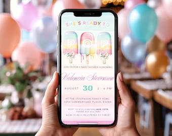 May include: A smartphone displays a baby shower invitation. The invitation features pastel-colored popsicles with the word "POP" and floral accents. The invitation is for Valencia Stevenson's baby shower on August 30th.