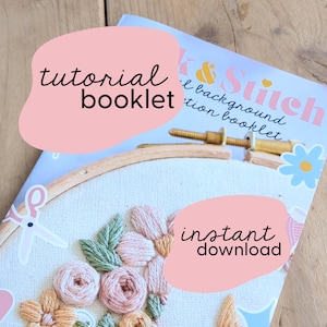 May include: A pink and white embroidery hoop with a floral design. The hoop is on top of a magazine with the text "Stitch & Back" and "Tutorial Booklet" on the cover. The text "Instant Download" is also visible on the image.