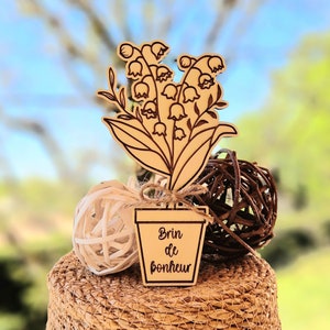 Sprig of lily of the valley in engraved wood, May 1st
