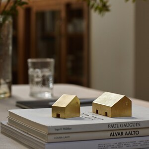 Cast brass ornaments, bookends, paperweights, house shapes