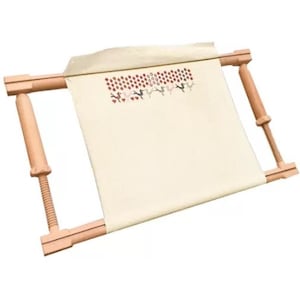 May include: A wooden embroidery frame with cream fabric stretched across it. The fabric displays a floral and bird design in red, pink, and green. The frame has adjustable wooden screws on each side for tensioning.