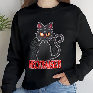 May include: Black sweatshirt with a black cat wearing a crown of thorns and the text "HECKRAISER" in red.