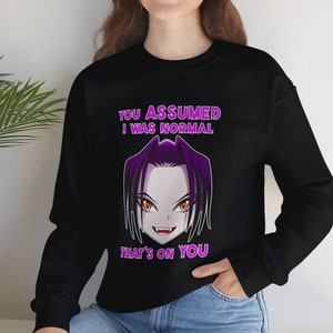 May include: Black sweatshirt with a purple and white anime character graphic. The text on the sweatshirt reads 