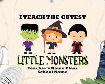 May include: A natural colored t-shirt with the text "I teach the cutest little monsters" and cartoon images of a Frankenstein, witch, and vampire. The text "Teacher's Name Class School Name" is also included.