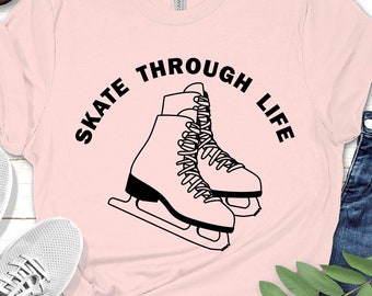 May include: Pink t-shirt with a black graphic of ice skates and the text "Skate Through Life".