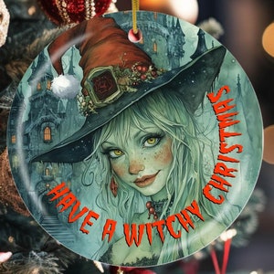 May include: A round Christmas ornament featuring a witch with green hair and a black hat. The background is a dark green and blue with a castle in the background. The text "Have a Witchy Christmas" is written in orange around the ornament.
