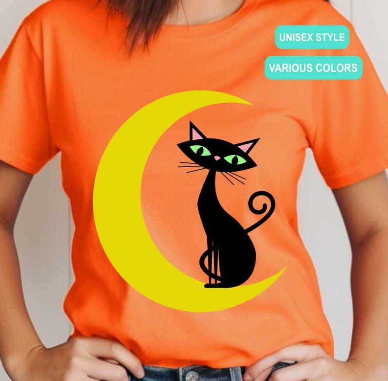 May include: An orange short-sleeve t-shirt featuring a graphic of a black cat with green eyes sitting on a yellow crescent moon. The shirt includes two rectangular text boxes with the words UNISEX STYLE and VARIOUS COLORS printed in white.