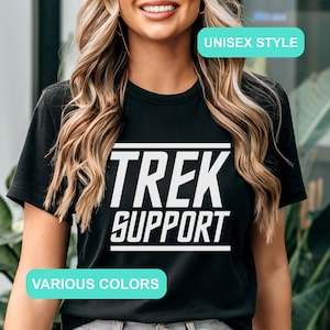 May include: Black t-shirt with white text that reads "TREK SUPPORT" in a bold, blocky font. The shirt is unisex style and available in various colors.