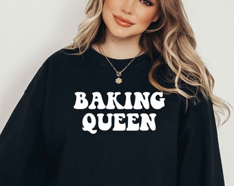 May include: Black sweatshirt with the text "Baking Queen" in white retro-style lettering.