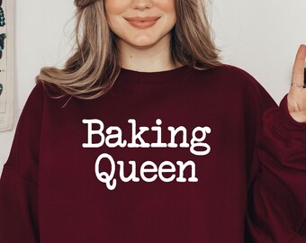 May include: A maroon sweatshirt with the text "Baking Queen" in white lettering.