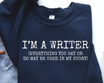 May include: A navy blue sweatshirt with white text that reads "I'm a writer (Everything you say or do may be used in my story)".