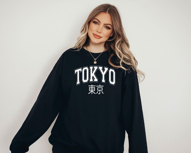 May include: Black sweatshirt with white text that says "TOKYO" and "東京" in Japanese characters.