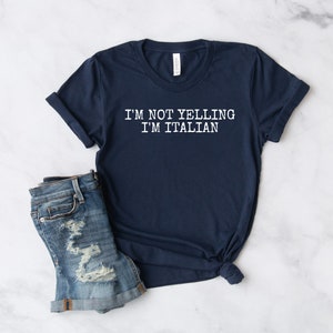 May include: A navy blue t-shirt with white text that reads "I'M NOT YELLING I'M ITALIAN".