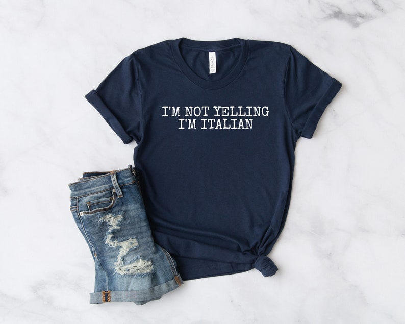 May include: A navy blue t-shirt with white text that reads "I'M NOT YELLING I'M ITALIAN".