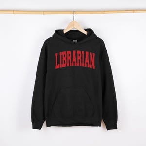 May include: Black hooded sweatshirt with a red "LIBRARIAN" graphic printed on the front.