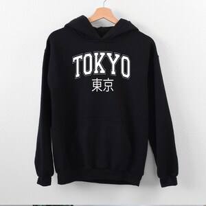 May include: Black hooded sweatshirt with white text that says "TOKYO" and the Japanese characters for Tokyo.