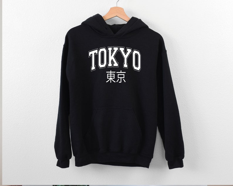 May include: Black hooded sweatshirt with white text that says "TOKYO" and the Japanese characters for Tokyo.