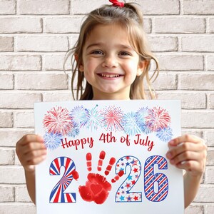 girl holding her completed 2026 handprint art for 4th of july
