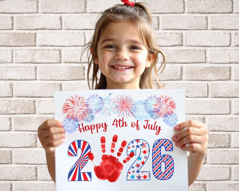 girl holding her completed 2026 handprint art for 4th of july