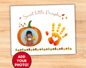 May include: A white card with an orange pumpkin frame holding a child's photo. The text "Sweet little Pumpkin" is above the pumpkin. A handprint with a heart is to the right, and a row of trees is at the bottom.
