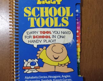 May include: A spiral-bound "Ziggy School Tools" book with a blue cover. The cover features the text "SCHOOL TOOLS" in yellow, along with a cartoon character and the phrase "EVERY TOOL YOU NEED FOR SCHOOL IN ONE HANDY PLACE!" Additional text includes "Alphabets, Circles..."