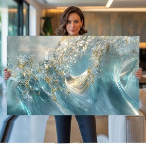 May include: A rectangular wall art piece featuring a dynamic, abstract representation of a crashing ocean wave. The artwork displays swirling shades of translucent light blue and white, accented with shimmering gold metallic details throughout.