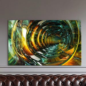 May include: Abstract art print featuring a swirling tunnel design. The artwork showcases a vibrant blend of colors, including green, yellow, and orange, creating a sense of depth and movement. The piece is mounted on a wall above a brown leather couch.